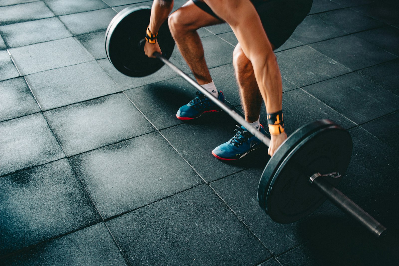 A barbell deadlift setup on a gym floor