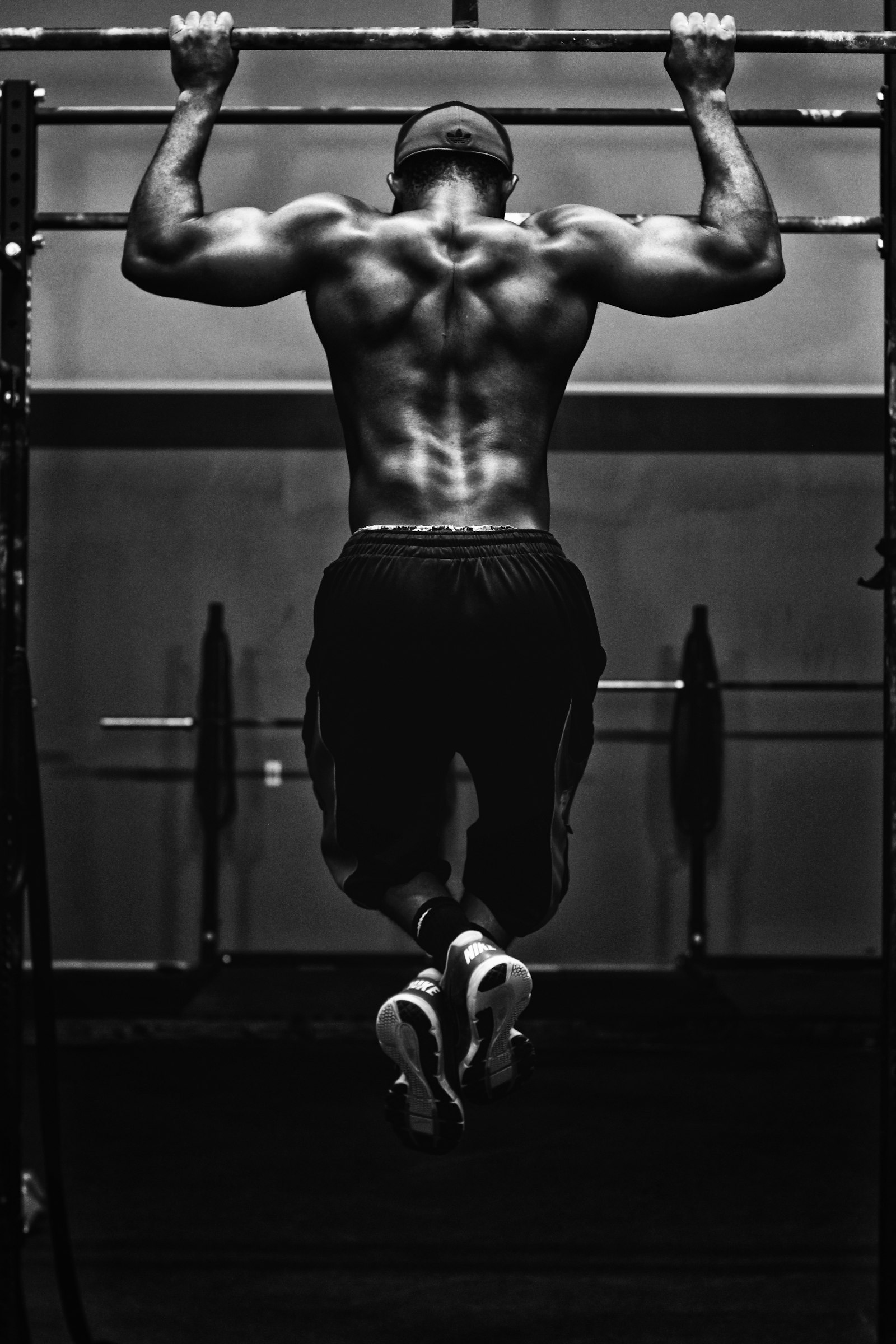 Person training with a pull-up bar in a gym